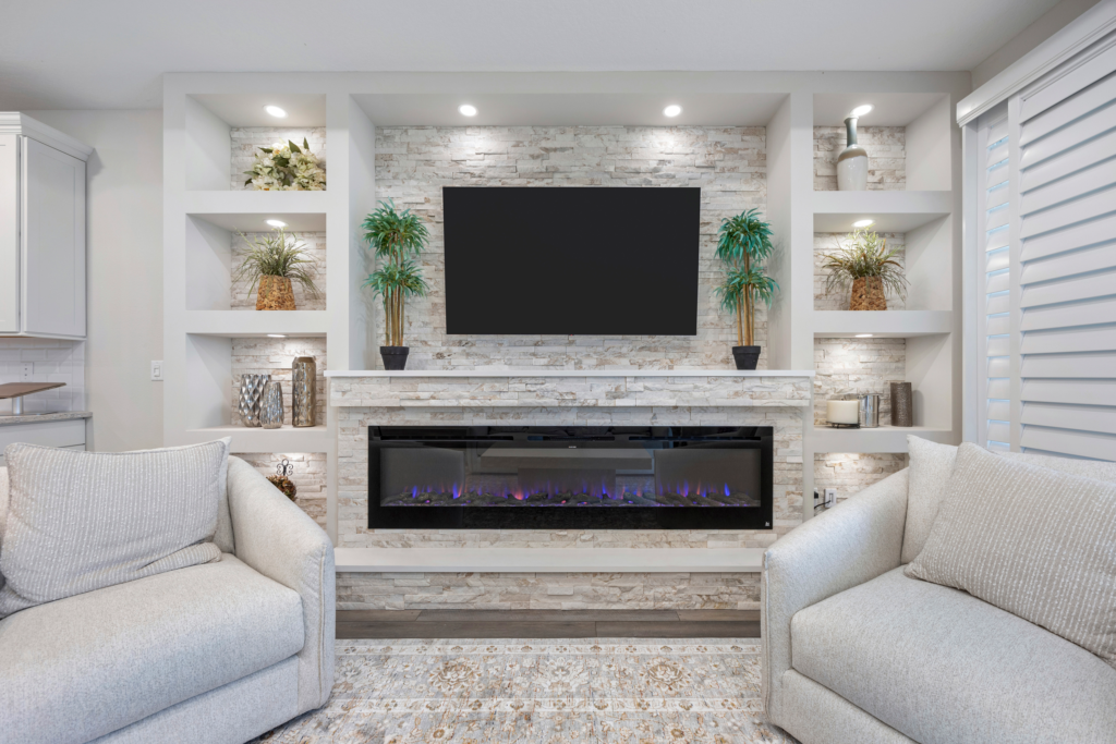 Custom built-in entertainment wall with stone surround and electric fireplace at 94 Hickory Pine Drive Summer Bay
